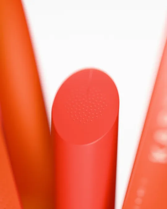The lipstick's slanted face with an embossed spiral of seeds